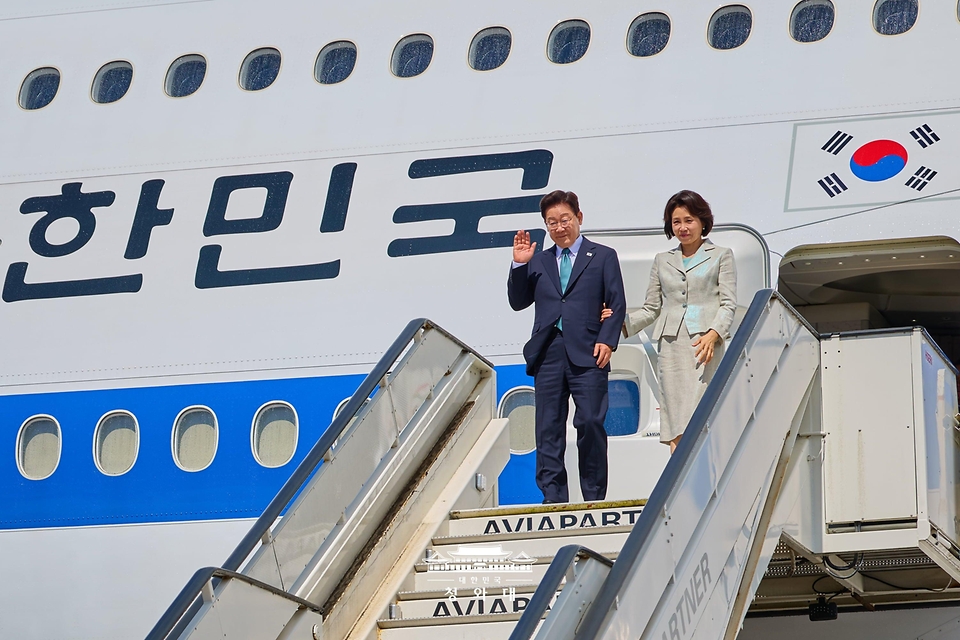 벨기에를 방문한 이재명 대통령과 김혜경 여사가 6월 9일(현지 시간) 브뤼셀 멜스부르크 공군 기지에 도착한 공군 1호기에서 환영객에게 인사하고 있다.
