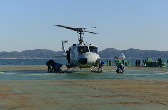 민간 선박 덱 캐리어 갑판에서 UH-1H 헬기가 이착륙 훈련을 하고 있다.
