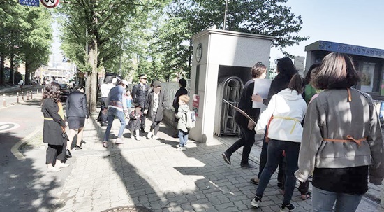 학교 정문 앞에서 아이들의 안전지도하는 모습