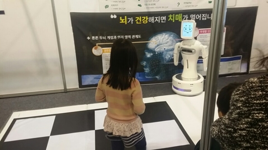 로보케어 부스에서 로봇 두뇌게임을 체험하고 있다.