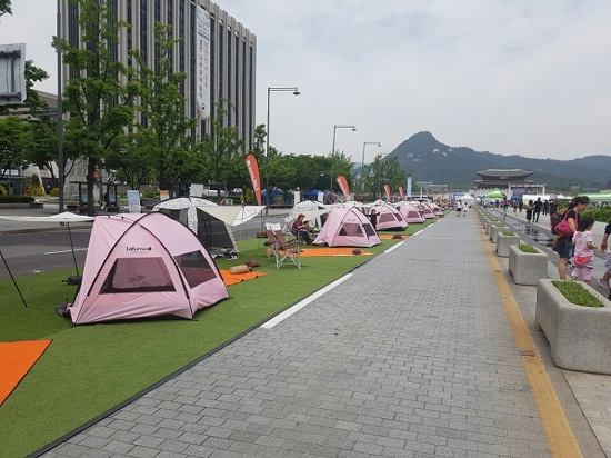 뜨거운 햇살이 내리 쬐고 있는 가운데 시민들이 텐트를 설치해 휴식을 갖고 있다.