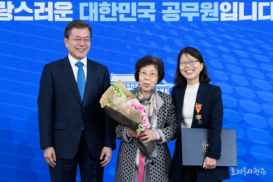 김남이 연구관(오른쪽)이 대한민국 공무원상 시상식에서 문재인 대통령과 어머니와 함께 기념촬영을 하고 있다.