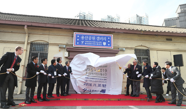 성장현 용산구청장을 비롯한 주요내빈들이 11월 30일 서울 용산구 캠프킴 부지내 옛 미국위문협회(USO)에서 열린 ‘용산공원 갤러리’개관식에서 제막을 하고 있다.