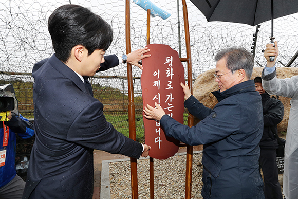 문재인 대통령이 영화배우 류준열 씨와 26일 오후 강원도 고성군 DMZ 평화의 길에 솟대를 설치해 팻말을 부착하고 있다. (사진=저작권자(c) 연합뉴스, 무단 전재-재배포 금지)