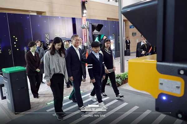 지난 3월 부산 벡스코에서 열린 스마트시티 전략발표회에 참석한 문재인 대통령과 참석자들이 스마트 신호등과 횡단보도를 체험하고 있다.