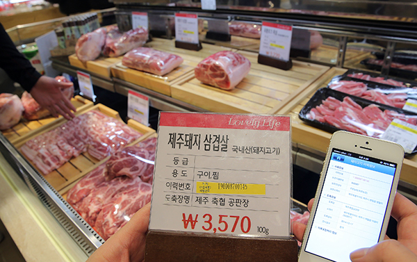 한 축산매장에서 직원이 돼지고기의 이력정보를 확인하고 있다.(사진=저작권자(c) 연합뉴스, 무단 전재-재배포 금지)