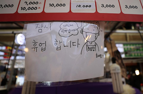 코로나19로 잠시 휴업을 알리는 문구가 적힌 남대문 시장의 한 점포. ‘다함께 이겨내자’는 응원의 메시지도 함께 적혀져 있다.