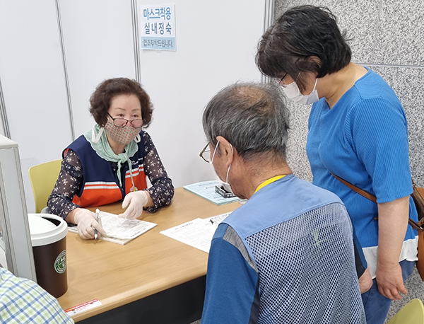 이규연 씨가 예방접종센터에 방문한 어르신의 예진표 작성을 돕고 있다. (사진=행정안전부)