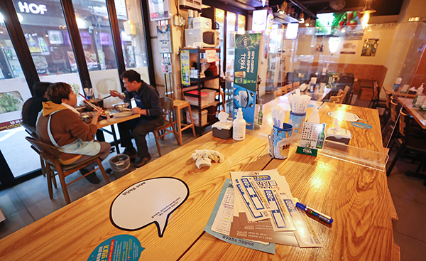서울의 한 음식점에서 자영업자가 식사를 하고 있다. 빈 테이블에는 안심콜 스티커가 놓여 있다.(사진=저작권자(c) 연합뉴스, 무단 전재-재배포 금지)