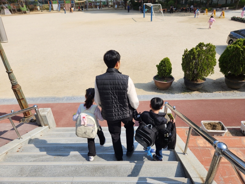 늘봄학교 프로그램 종료 후 강사가 아이들을 인솔해서 교문까지 데려다주고 있다.