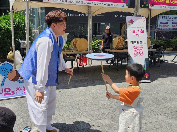 공연에 앞서 아이가 남사당놀이의 하나인 버나돌리기를 체험하고 있다.