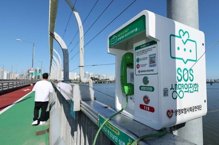 세계 자살 예방의 날인 10일 서울 마포대교에 설치된 생명의 전화 앞으로 시민이 지나가고 있다.(ⓒ뉴스1, 무단 전재-재배포 금지)