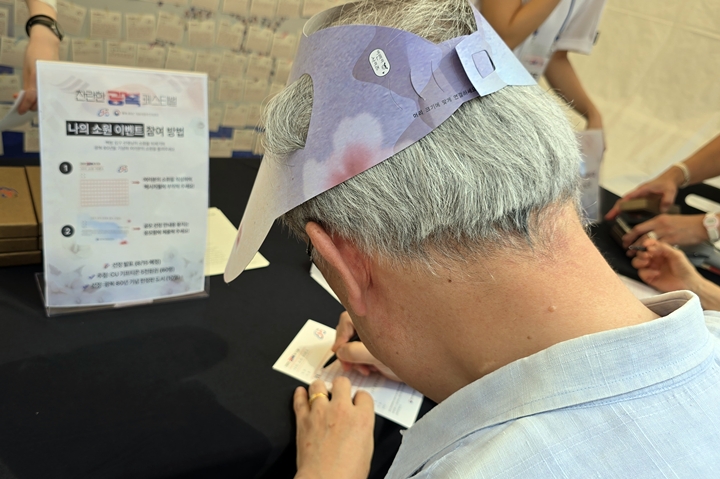 어르신이 소원을 적고 있다.