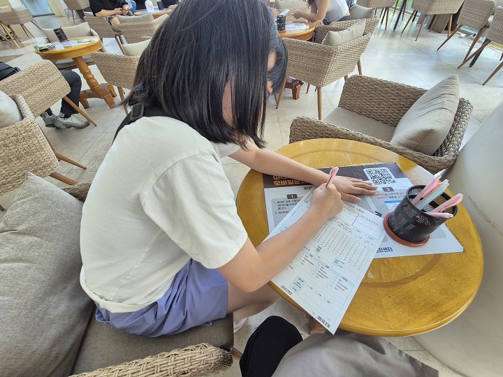 학생건강검진 기록지를 직접 작성 중인 자녀.