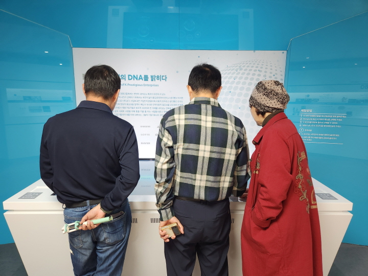 관람객을 위한 체험 시설도 있다. 여러 관람객이 키오스크 단말기에 집중하고 있다.