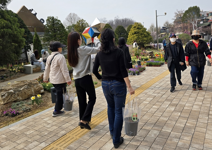 목수국을 받아든 사람들 발걸음이 유난히 가벼워보인다. <본인촬영>